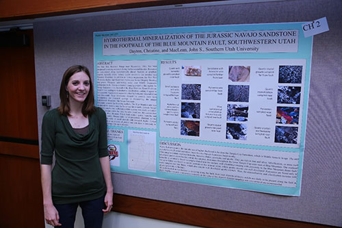 Christine Dayton in front of her research poster.