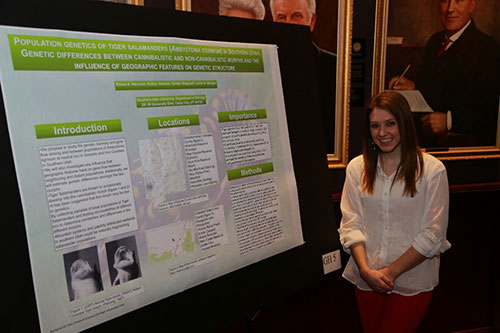 A female with a research poster
