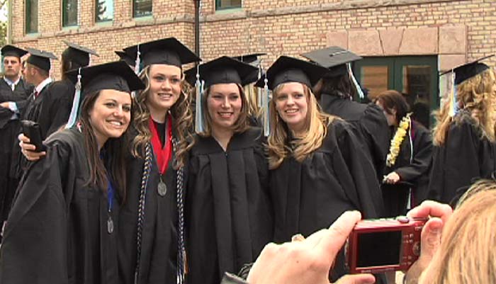 Photo of camera taking a picture of SUU's graduates.