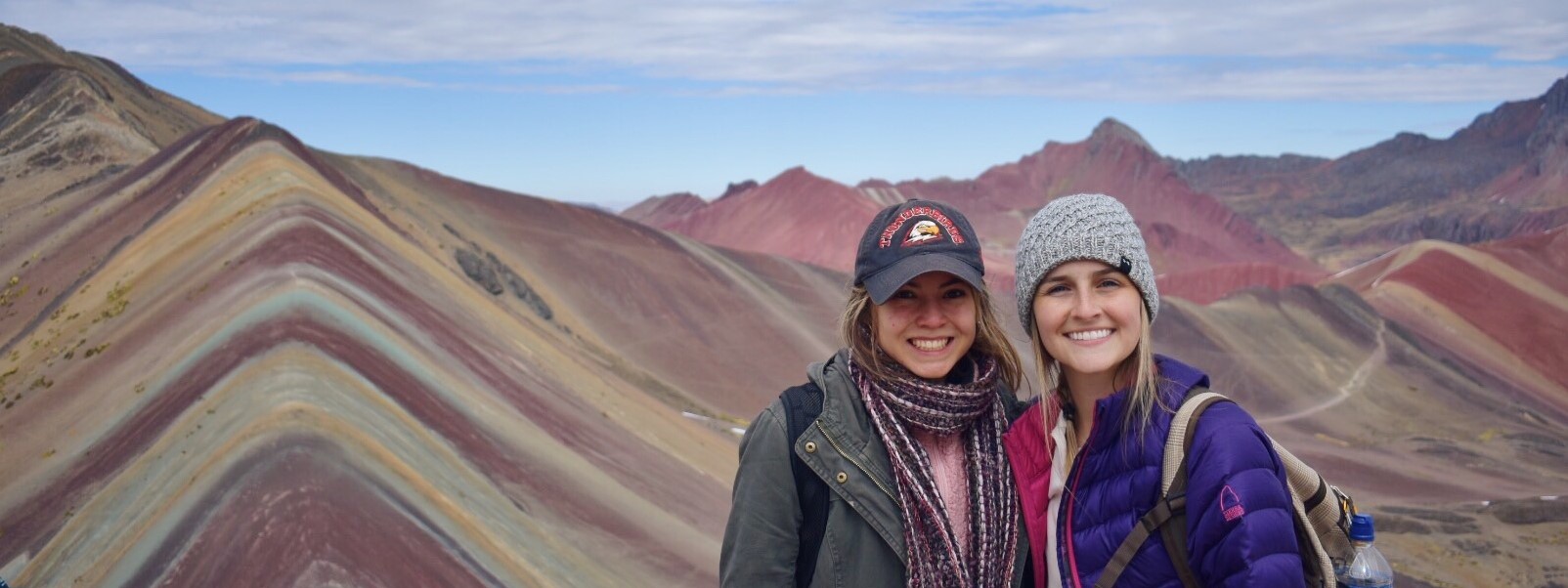 2 girls pictured in front of mountains