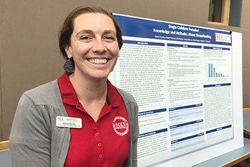 Dietetic Student standing in front of research postr