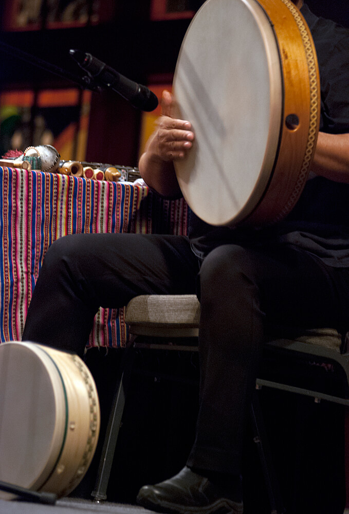 Microphone and a hand-drum that is being played 6