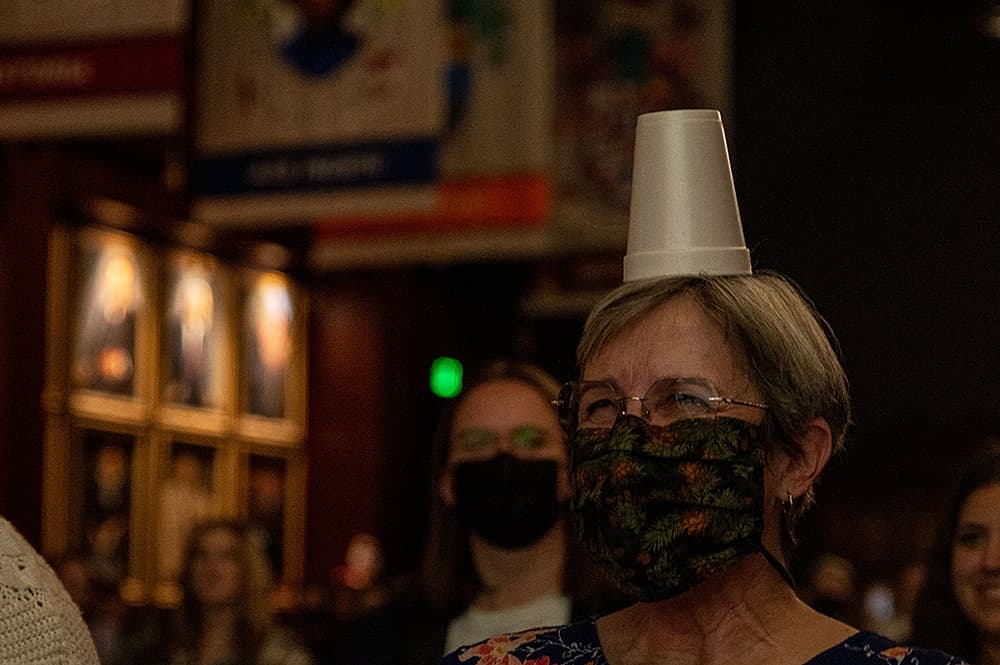 Audience Member with cup on their head 8