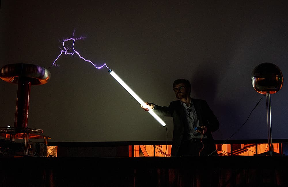 Brandon Wiggins lighting a Lightbulb with Tesla Coils 18