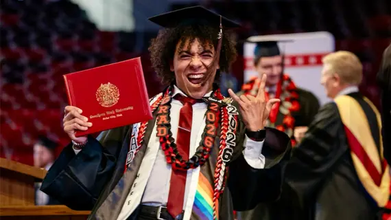 Photo of Tyrese Sheriff walking across the stage at the 2026 Degree Convocation.