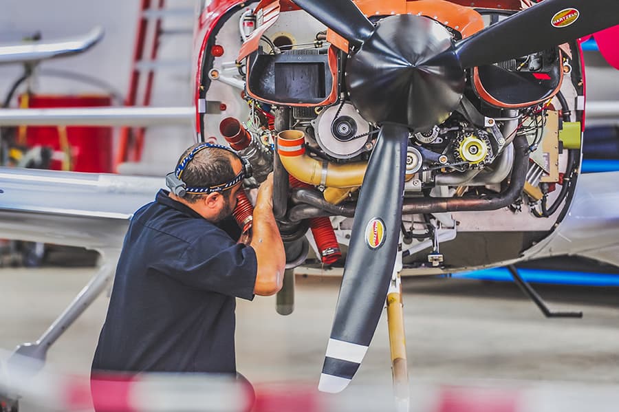 Aviation Maintenance Technician working on a helicopter