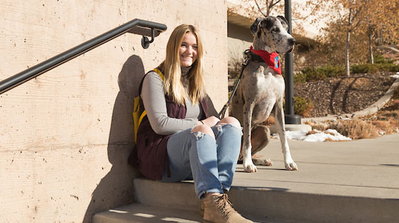 Student with dog on campus