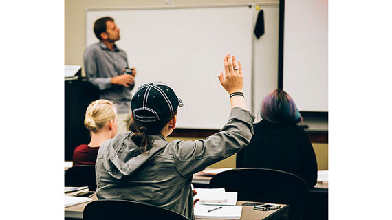 student raising hand in class
