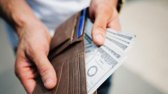 Person taking money out of wallet