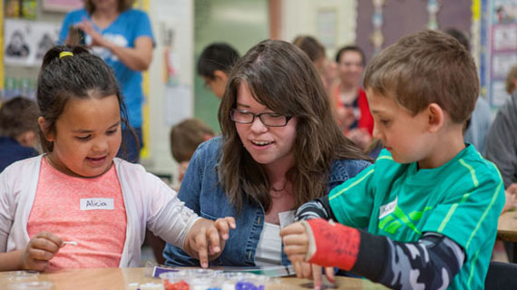 Two young students and their teacher