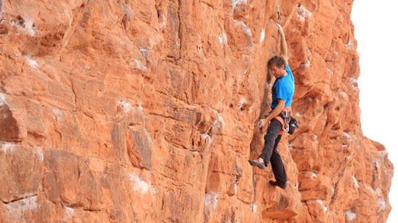 person climbing a rock wall