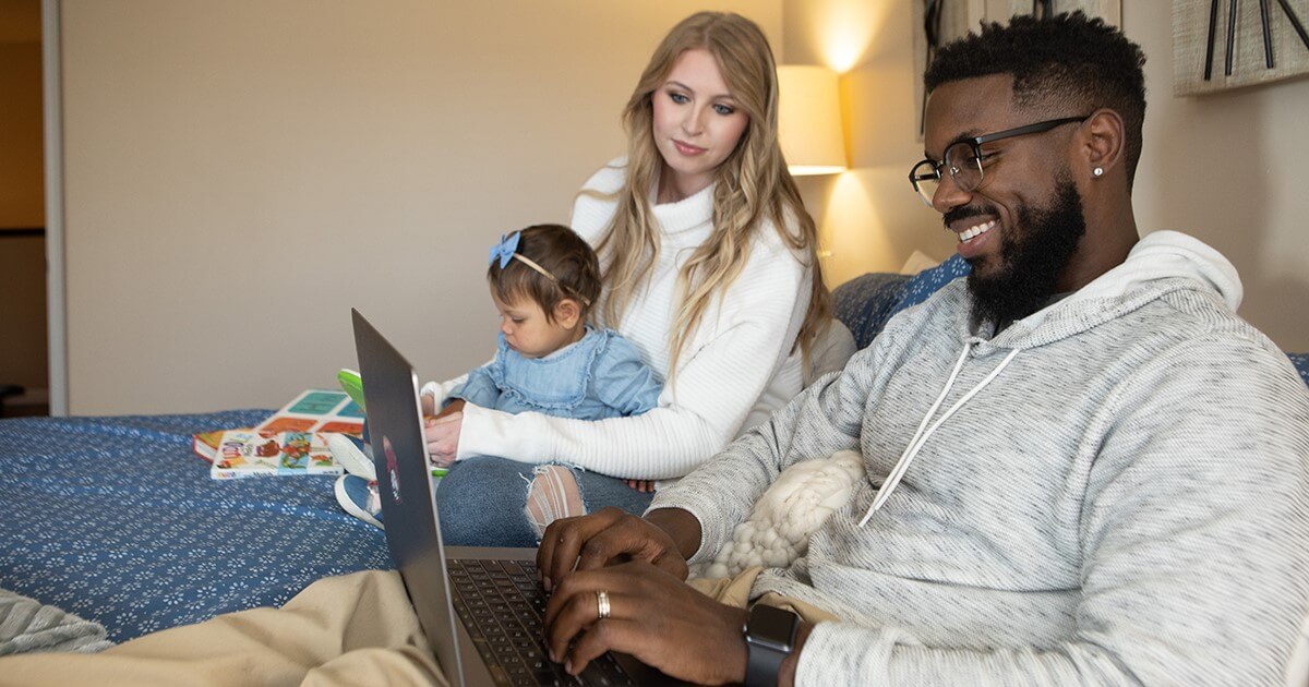 Parents with baby looking at laptop