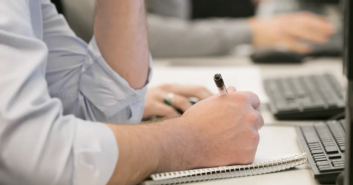 A student writing in a notebook