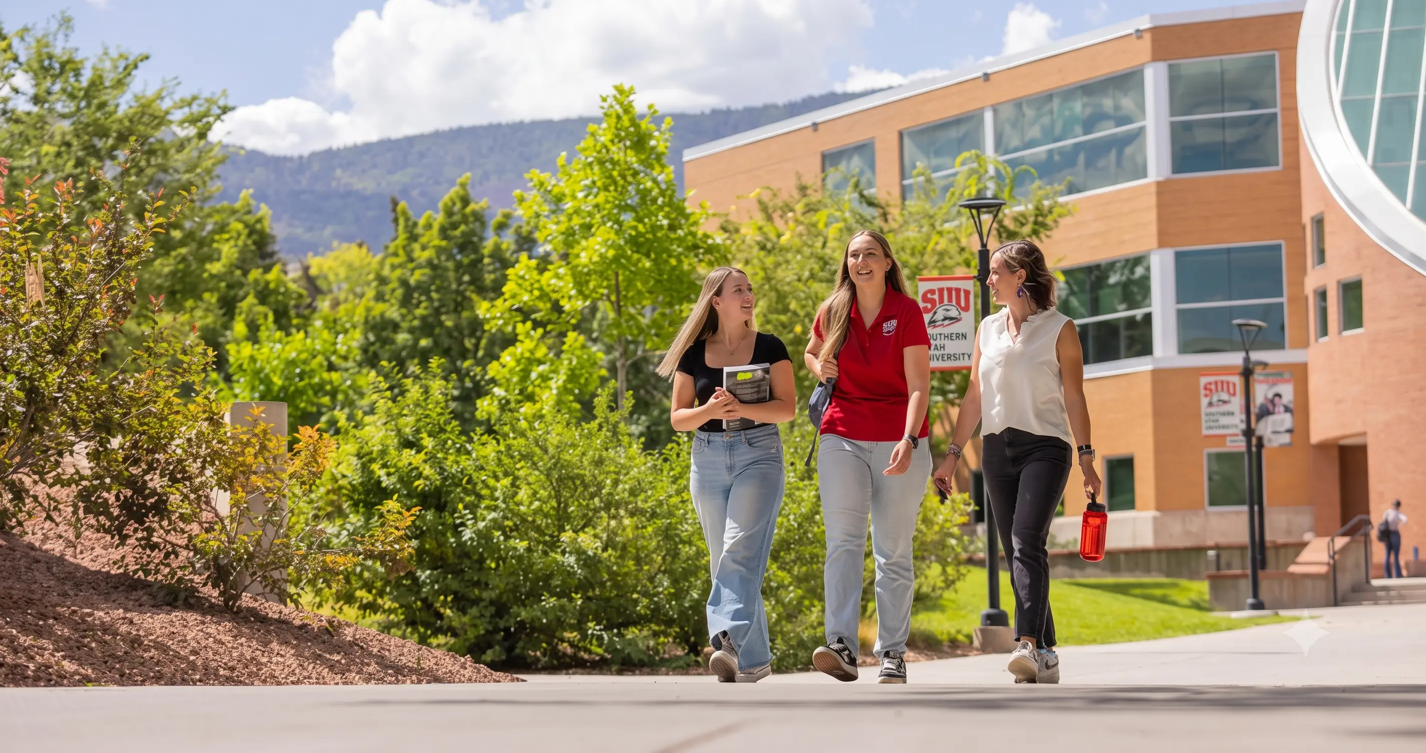 Students walking together outside in front of the SUU Library