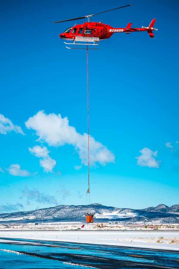 helicopter lowering bag onto road