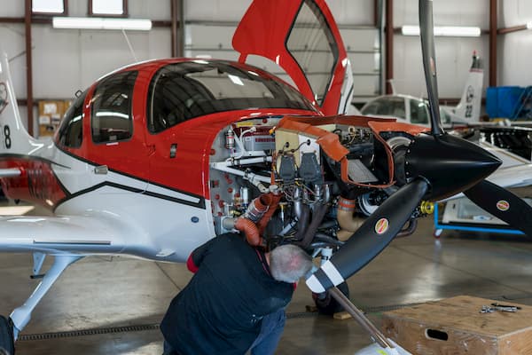Airplane mechanic fixing flane