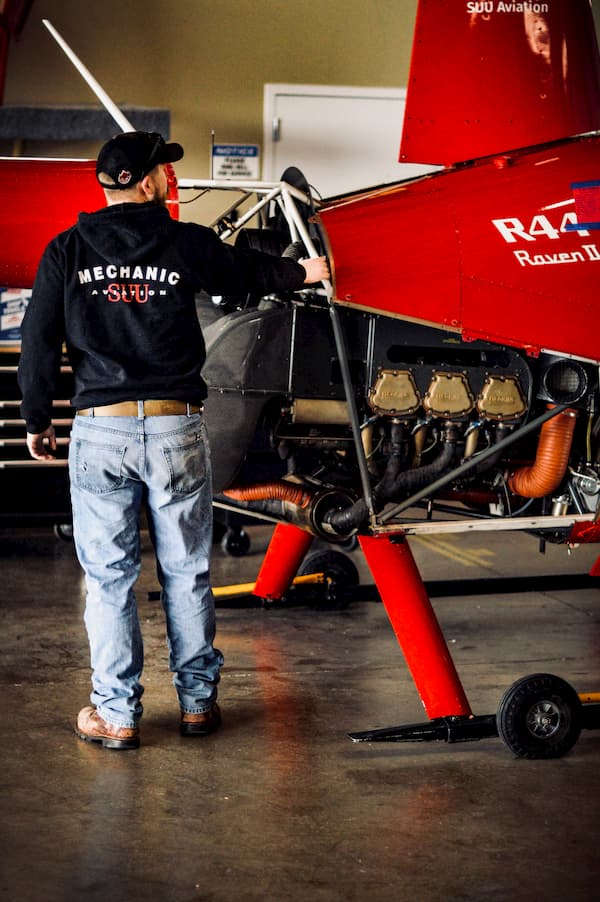 SUU Aviation student A&P Mechanic working on an R44 Raven II Helicopter