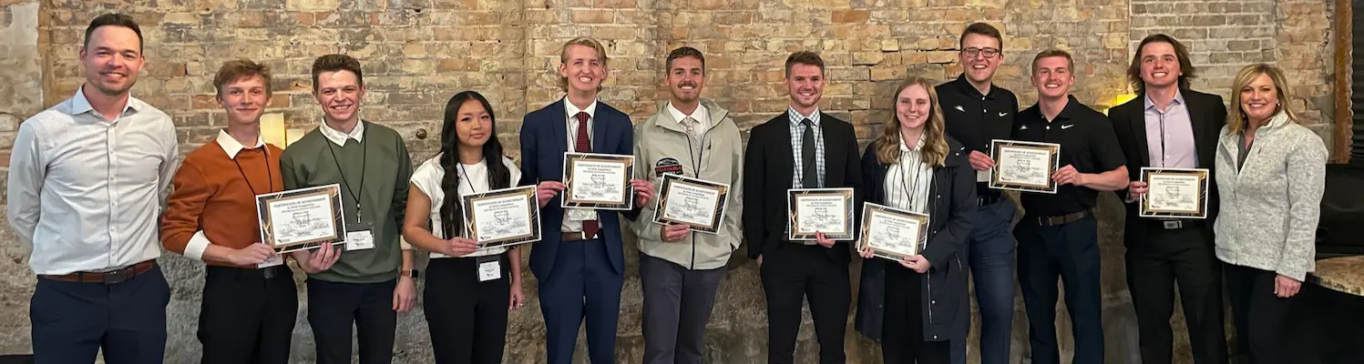 2023 S4 competition winners standing against a brick wall with their awards and the program directors