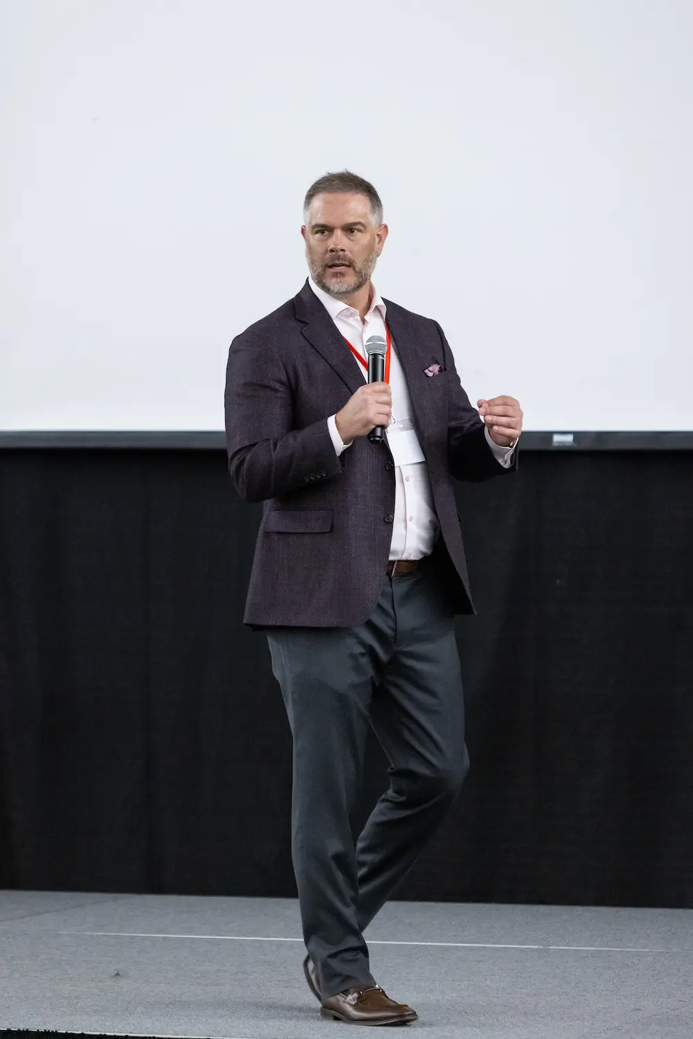 A man presenting with a microphone 1