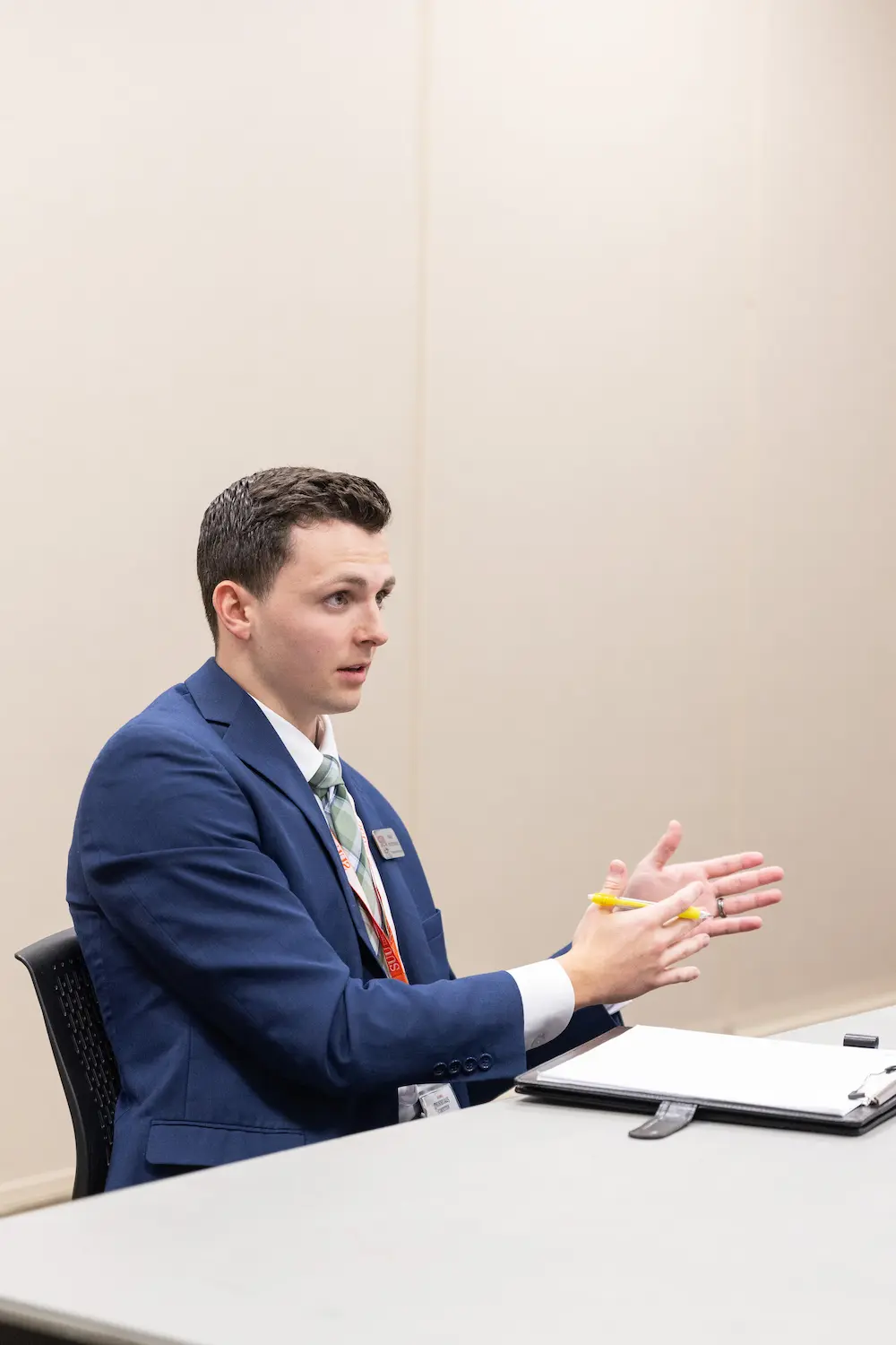 A man presenting at a table 5