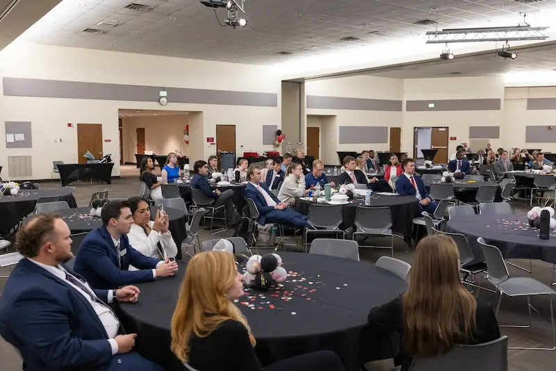 Students sitting at table watching presentation 14