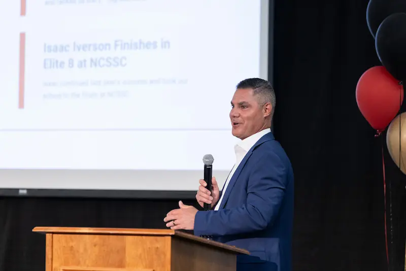 A man presenting with a microphone 4 15