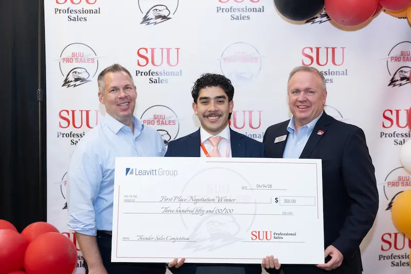 A student posing with check 16