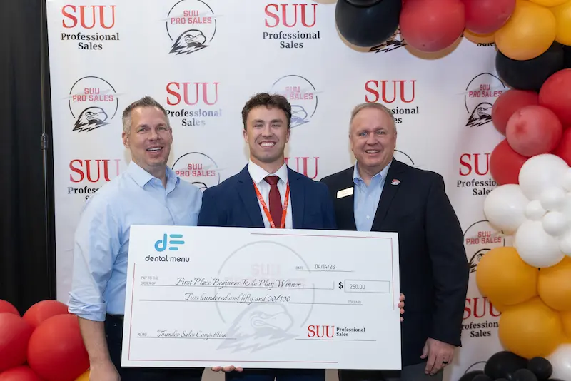 A student posing with check 4 19