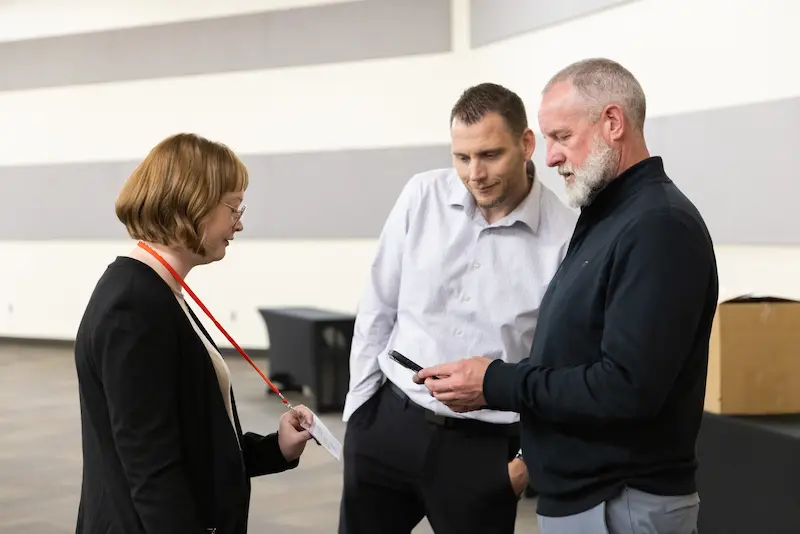 Two men talking to a student 25