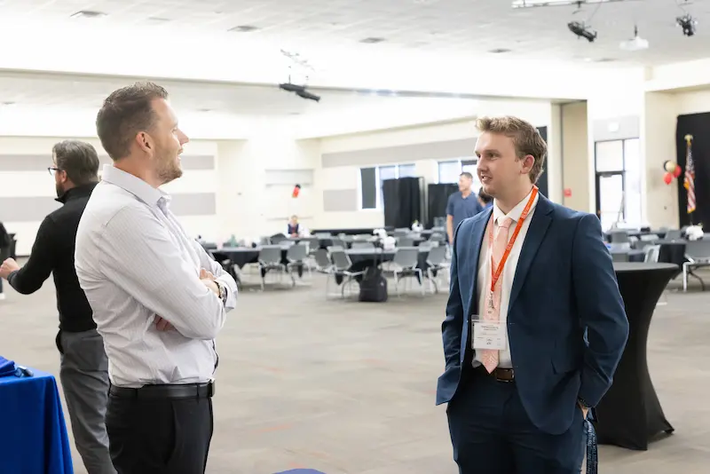 A man talking to a student 26