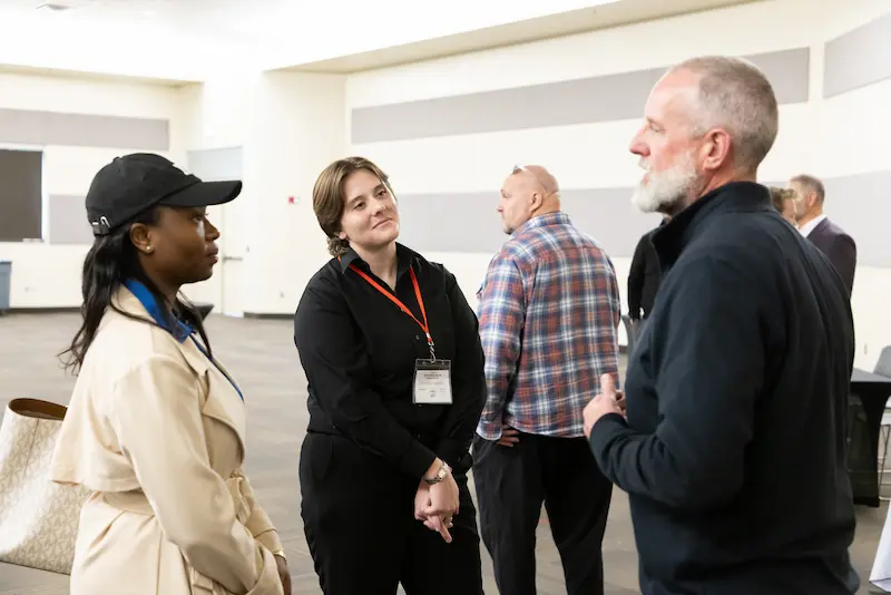 Three attendees talking to each other 29
