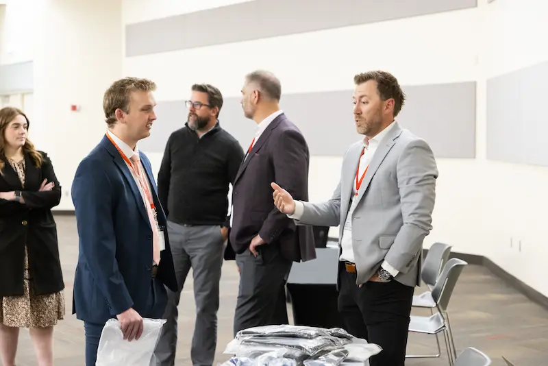 Two men discussing at a booth 30