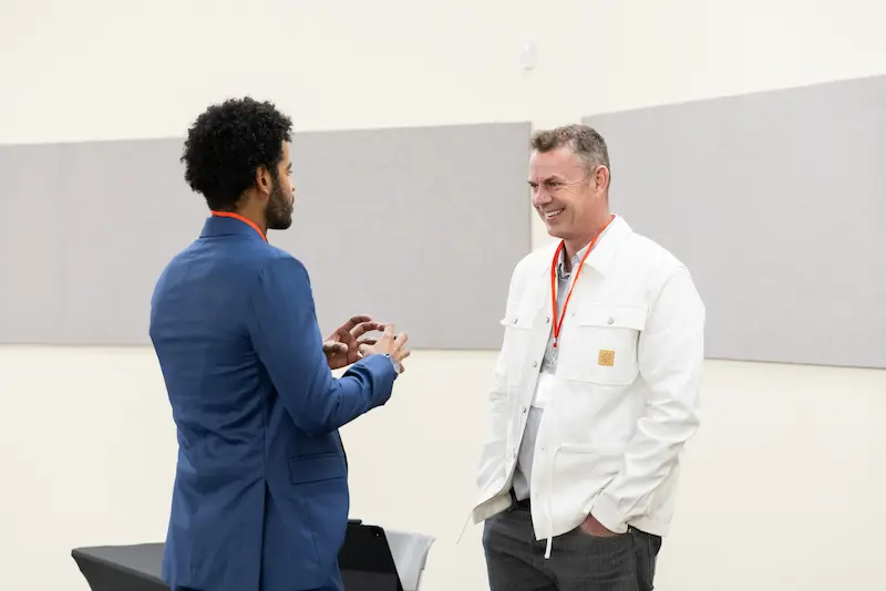 Two men discussing at a booth 2 31