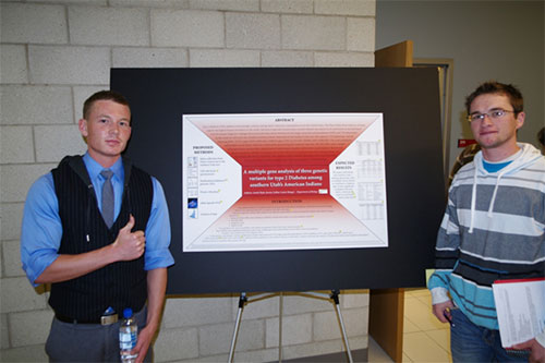 Two boys standing with their research poster