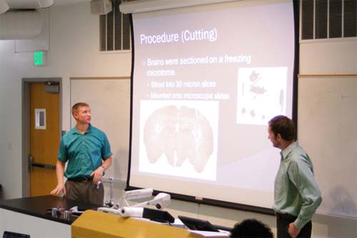 Michael Barney and Joe Keeler standing at the front of a classroom giving a presentation