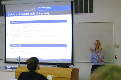 Emma Turner at the front of a classroom presenting her research