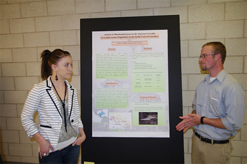 Two students with their research poster