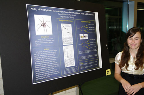 Sarah Miller standing with her research poster
