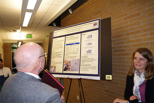 Robert Eves examining a student's research poster