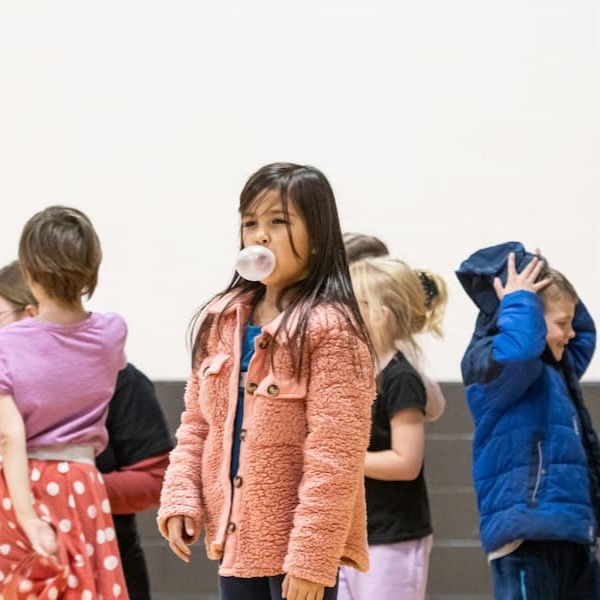 Elementary student blowing a bubblegum bubble