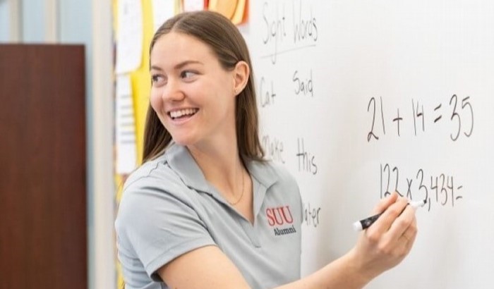 Student teacher writing on white board