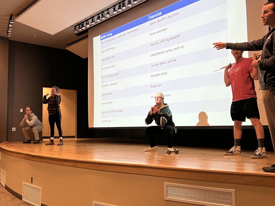 March 2023: Exercise Science club leaders performing exercises at a EIM Seminar Series 1