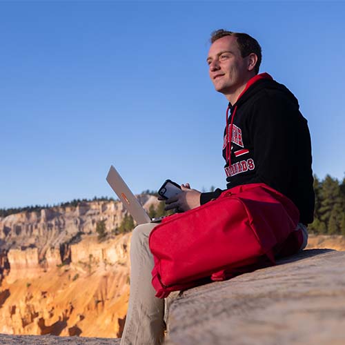 Student outside on computer