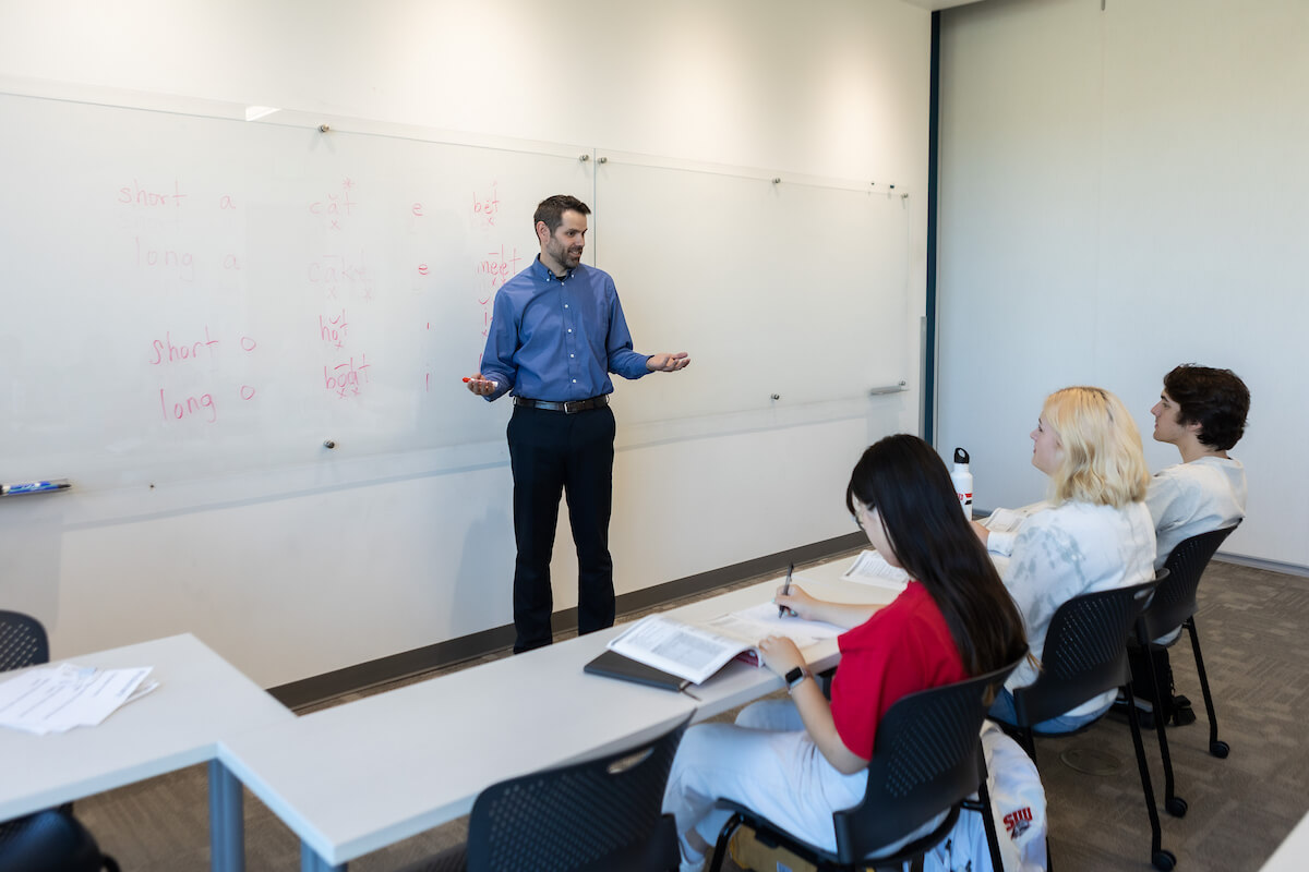 A professor giving a lecture in a classroom