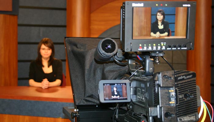 Photo of student preparing for a newscast at SUTV.