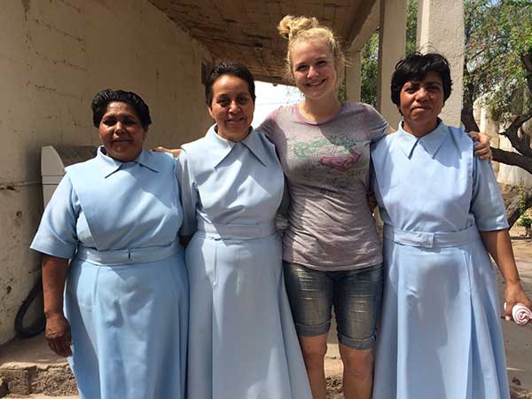 Photo of Mckenna Poulter with two nuns