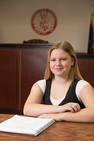 young woman in courtroom earning an online bachelors degree in criminal justice at suu