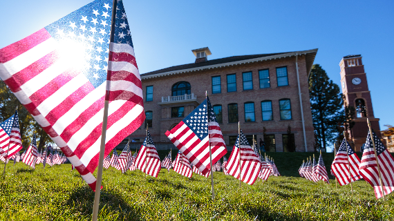 American flags on lawn in front of Old Main building