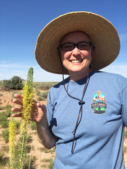 Dr. Jackie Grant holding a native plant