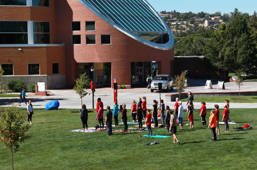 Students doing yoga on the Business Quad
